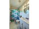 Bathroom with shower/tub combo, vanity, and floral shower curtain at 4851 Orange Ave, Port Orange, FL 32127