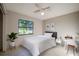 Bright bedroom with a queen bed, desk, and window at 4851 Orange Ave, Port Orange, FL 32127