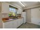 Galley style kitchen with white cabinets and appliances at 4851 Orange Ave, Port Orange, FL 32127
