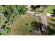 Aerial view of a property with a large yard, RV parking, and surrounding mature trees at 1195 Glen Royal Ter, Deland, FL 32720