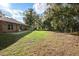 Over-sized, grassy backyard with large shady trees and a patio area at 1195 Glen Royal Ter, Deland, FL 32720