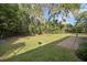 Lush backyard with shade trees, a spacious lawn, and a patio, perfect for relaxing at 1195 Glen Royal Ter, Deland, FL 32720