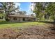 Large backyard featuring a patio, lawn, and shade trees, ideal for entertaining at 1195 Glen Royal Ter, Deland, FL 32720