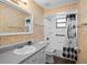 Tiled bathroom offers a vanity with sink, shower, and decorative shower curtain at 1195 Glen Royal Ter, Deland, FL 32720