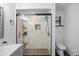 Bright bathroom featuring a walk-in shower, shiplap walls, and modern fixtures at 1195 Glen Royal Ter, Deland, FL 32720