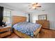 Comfortable bedroom featuring wood floors, ceiling fan, and a wooden dresser at 1195 Glen Royal Ter, Deland, FL 32720