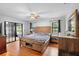 Spacious bedroom with wood floors, a large window, and stylish furniture at 1195 Glen Royal Ter, Deland, FL 32720