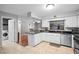 Updated kitchen with white cabinets, stainless steel appliances, and a stylish backsplash at 1195 Glen Royal Ter, Deland, FL 32720
