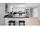 Bright kitchen featuring white cabinets, stainless steel appliances, and a breakfast bar with seating at 1195 Glen Royal Ter, Deland, FL 32720