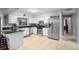 Modern kitchen with stainless steel appliances, white cabinetry, tiled floors and view to dining area at 1195 Glen Royal Ter, Deland, FL 32720