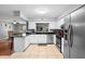 Bright kitchen with stainless steel appliances, tiled floors, breakfast bar, and view to dining area at 1195 Glen Royal Ter, Deland, FL 32720