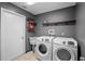 Laundry room with modern washer and dryer, sink, and practical shelving for storage at 1195 Glen Royal Ter, Deland, FL 32720
