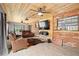 Inviting living room with wood accents, cozy seating, and a large television at 1195 Glen Royal Ter, Deland, FL 32720