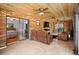 Stylish living room featuring exposed brick, wood ceiling, and leather seating at 1195 Glen Royal Ter, Deland, FL 32720