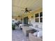 Spacious covered patio featuring brick pavers, comfortable seating and ceiling fans, perfect for outdoor living at 1227 Victoria Hills, Deland, FL 32724