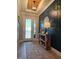 Inviting entryway with wood accent wall, designer lighting, console table, and patterned runner rug at 1227 Victoria Hills, Deland, FL 32724