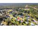Picturesque aerial shot of a neighborhood, showcasing lush greenery and interspersed homes against a backdrop of dense forest at 1437 Colin Kelly Ave, Daytona Beach, FL 32124