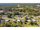 This attractive home is captured from an aerial view, showing its placement among the lush trees of the surrounding neighborhood at 1437 Colin Kelly Ave, Daytona Beach, FL 32124