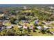 Picturesque aerial shot of a neighborhood, showcasing lush greenery and interspersed homes against a backdrop of dense forest at 1437 Colin Kelly Ave, Daytona Beach, FL 32124