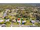 This aerial view showcases a charming single-story home with a spacious, well-maintained lawn in a verdant, peaceful neighborhood at 1437 Colin Kelly Ave, Daytona Beach, FL 32124