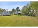 Expansive backyard with plenty of green space and a shed at 1437 Colin Kelly Ave, Daytona Beach, FL 32124