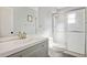Modern bathroom featuring a sleek gray vanity, a white countertop, and a glass-enclosed shower for a clean, updated look at 1437 Colin Kelly Ave, Daytona Beach, FL 32124