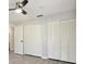 This bedroom showcases spacious storage with floor-to-ceiling closet doors, along with modern gray laminate flooring at 1437 Colin Kelly Ave, Daytona Beach, FL 32124