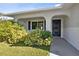 Close up of the covered front entry with a view of the lush landscaping at 1437 Colin Kelly Ave, Daytona Beach, FL 32124