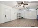 Spacious garage with updated flooring, a modern ceiling fan, and ample room for vehicles and storage at 1437 Colin Kelly Ave, Daytona Beach, FL 32124
