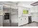 Modern kitchen featuring stainless steel appliances and contrasting cabinets with a view to the outdoors at 1437 Colin Kelly Ave, Daytona Beach, FL 32124