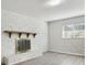 Living room with white brick fireplace and hearth, light gray walls, and wood-look floors at 1437 Colin Kelly Ave, Daytona Beach, FL 32124