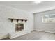 Cozy living room with a brick fireplace and large window offering plenty of natural light at 1437 Colin Kelly Ave, Daytona Beach, FL 32124