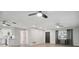 Open-concept living area featuring a modern ceiling fan, and an exterior entrance door at 1437 Colin Kelly Ave, Daytona Beach, FL 32124