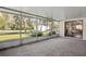 Enclosed screened patio with beautiful views of mature landscaping, shed, and lush green lawn at 1437 Colin Kelly Ave, Daytona Beach, FL 32124