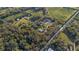 Expansive aerial view of a rural property, showcasing its secluded location amidst farms, ponds, and wooded areas at 227 N Putnam Grove Rd, Oak Hill, FL 32759