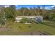 House with a large green yard and surrounding trees at 227 N Putnam Grove Rd, Oak Hill, FL 32759