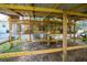 Outdoor animal pen with multiple partitioned sections made of wire mesh and wood frame at 227 N Putnam Grove Rd, Oak Hill, FL 32759