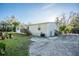 Large backyard with grass, wood deck and stairs leading to the residence at 227 N Putnam Grove Rd, Oak Hill, FL 32759