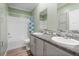 Clean bathroom with double vanity and shower/tub combo at 227 N Putnam Grove Rd, Oak Hill, FL 32759