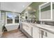 Bright bathroom featuring a soaking tub, modern vanities, and ample counter space for a luxurious experience at 227 N Putnam Grove Rd, Oak Hill, FL 32759