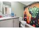 Quirky bathroom with unique character, a single sink vanity, and a vibrant shower curtain at 227 N Putnam Grove Rd, Oak Hill, FL 32759