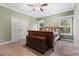 Bedroom with ceiling fan, neutral color palette, and a decorative bed and trunk at 227 N Putnam Grove Rd, Oak Hill, FL 32759