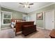 Cozy bedroom with carpet, two windows for natural light, neutral paint, and a ceiling fan at 227 N Putnam Grove Rd, Oak Hill, FL 32759