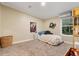 Small bedroom with carpet, a bed, one window, and light-colored walls at 227 N Putnam Grove Rd, Oak Hill, FL 32759