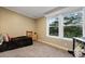 Bedroom featuring carpet, a small bed frame and dresser, and natural light from the double window at 227 N Putnam Grove Rd, Oak Hill, FL 32759