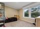 Bedroom featuring carpet, a small bed frame and dresser, and natural light from the double window at 227 N Putnam Grove Rd, Oak Hill, FL 32759