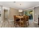 Dining room with a wooden table set, contemporary lighting, and sliding glass doors to outdoor living at 227 N Putnam Grove Rd, Oak Hill, FL 32759