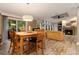 Dining area with wood floors, views of the living room fireplace and outdoor patio through sliding doors at 227 N Putnam Grove Rd, Oak Hill, FL 32759