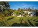 Inviting home exterior with lush greenery, featuring a well-maintained lawn and landscaping at 227 N Putnam Grove Rd, Oak Hill, FL 32759