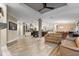 Open-concept living room with wood floors flowing into the kitchen and dining area featuring a coffered ceiling at 227 N Putnam Grove Rd, Oak Hill, FL 32759